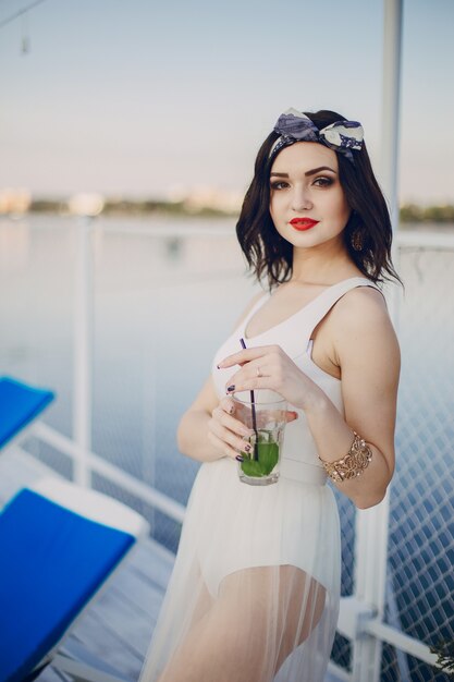 Young girl drinking from glass while smiling