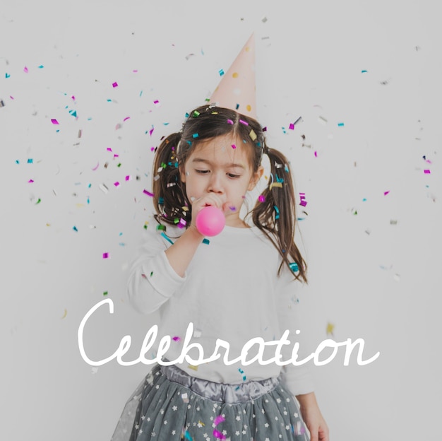 Young girl enjoying blowing balloon party celebration