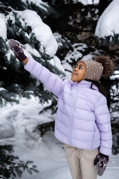 Young girl enjoying a snowy winter day outdoors