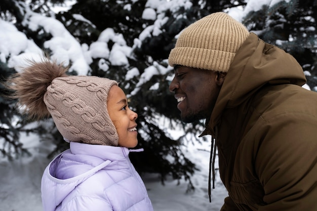 Young girl enjoying a winter day outdoors with her father