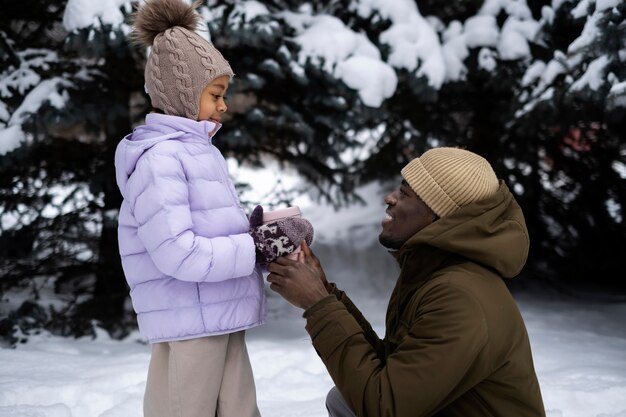 Young girl enjoying a winter day outdoors with her father