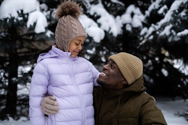 Young girl enjoying a winter day outdoors with her father