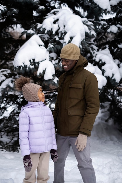 Young girl enjoying a winter day outdoors with her father