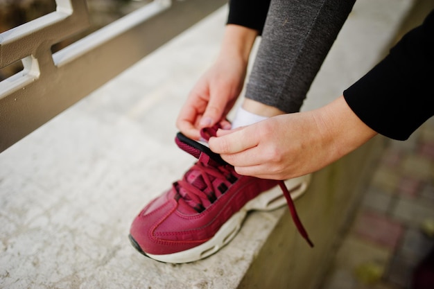 Free photo young girl has the training knit laces on sneakers sport fitness street workout concept