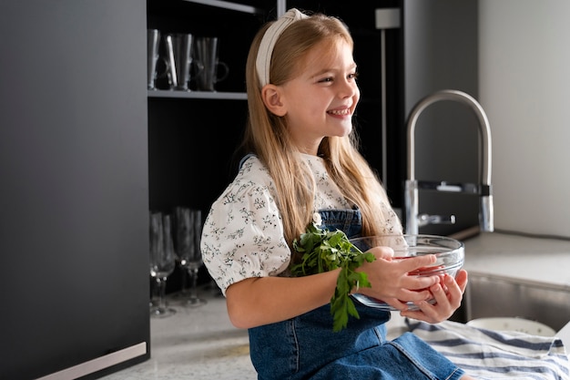 Free photo young girl helping with the cooking