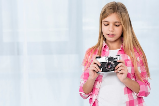 Young girl holding camera