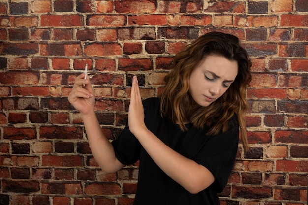 Young girl holding cigarette and gesture NO. High quality photo