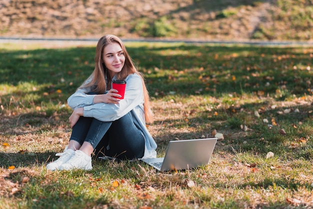 Young girl holding a cup in the nature