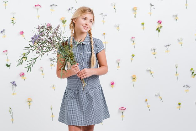 Young girl holding flowers bouquet