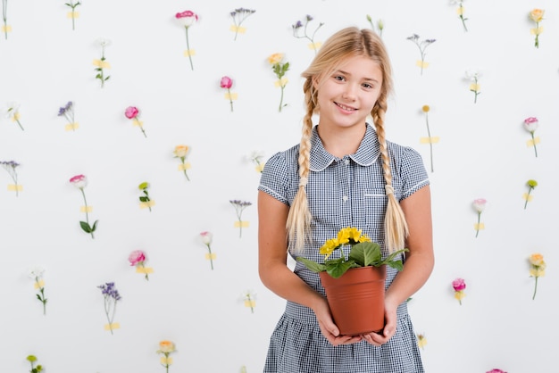 Young girl holding flowers pot