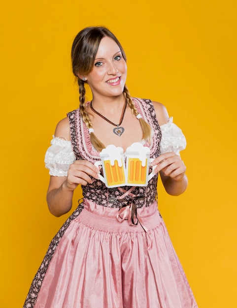 Free photo young girl holding paper mugs of beer