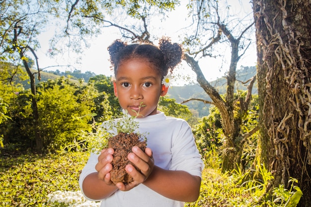 Young girl holding piece of soil