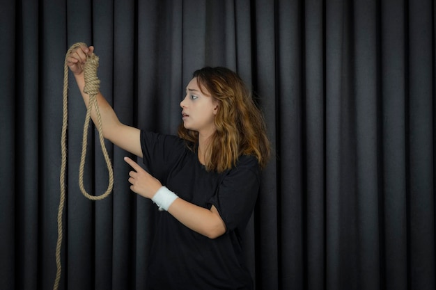 Free photo young girl holding suicide rope and saying no to it. high quality photo