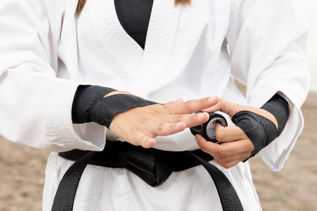 Free photo young girl in karate costume and belt