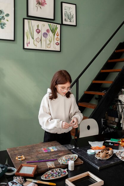 Young girl making diy crafts in upcycle project