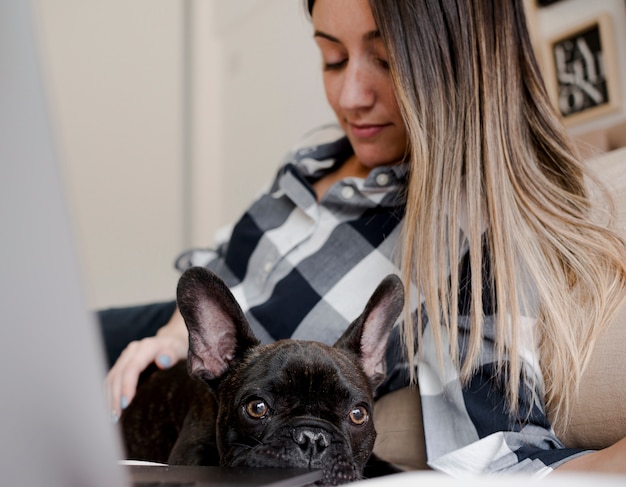 Free photo young girl petting her french bulldog