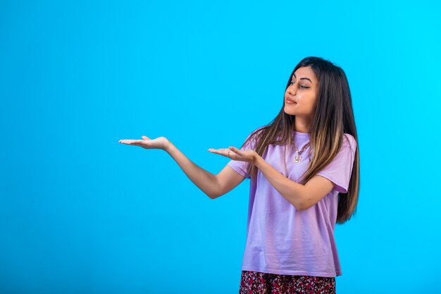 Young girl pointing at something .