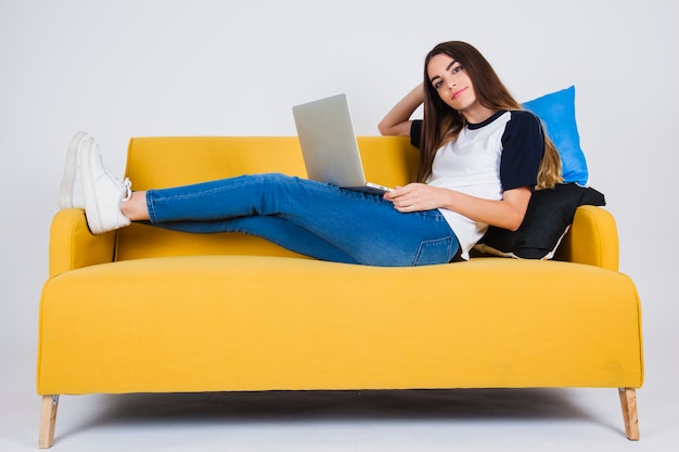 Young girl relaxing with lap top