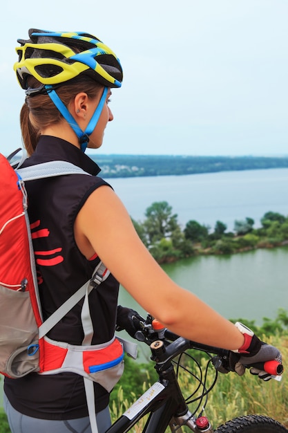 Free photo young girl riding bicycle outside