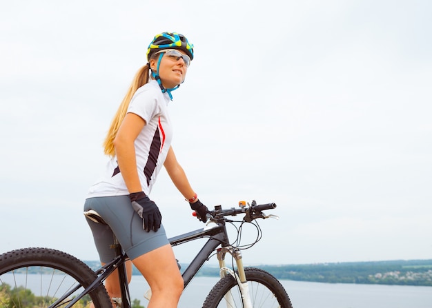 Young girl riding bicycle outside