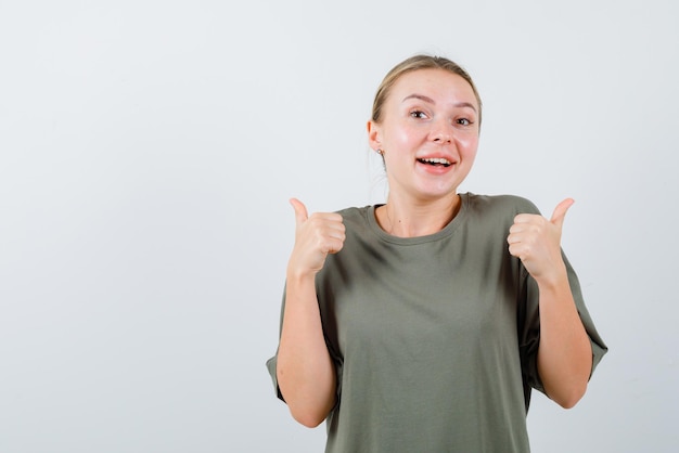 Young girl showing a good hand gesture on white background