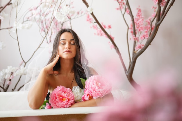 Young girl sitting in a bathtub and closed her eyes High quality photo