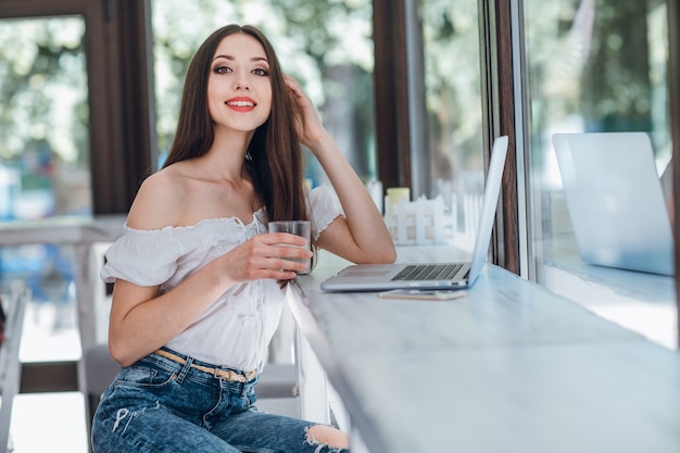 Young girl smiling with a glass in her hand