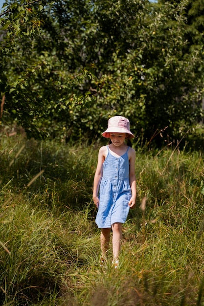 Young girl spending time outdoors in a rural area enjoying childhood