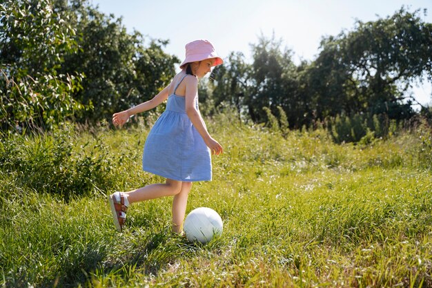 Young girl spending time outdoors in a rural area enjoying childhood