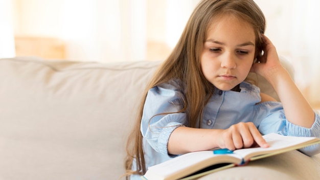 Young girl studying at home with copy space