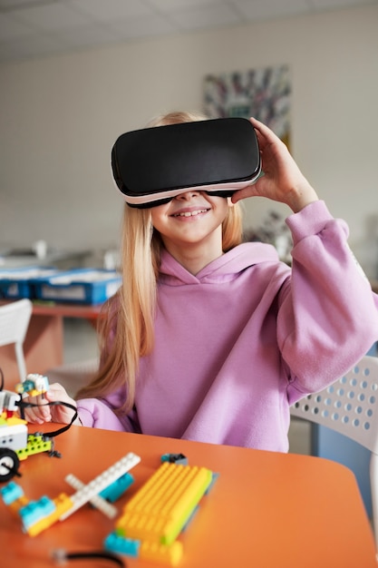 Free photo young girl trying out vr glasses and having fun