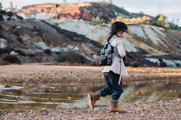 Young girl walking at river