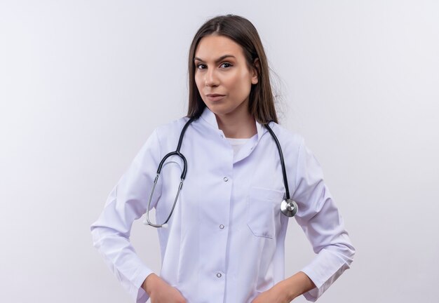 young girl wearing stethoscope medical gown on isolated white wall