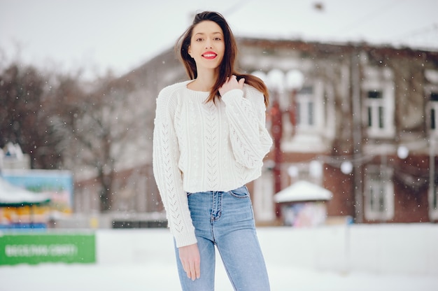 Free Photo young girl in a white sweater standing in a winter park