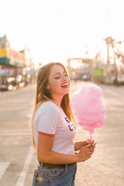 Free Photo young girl with cotton candy in the amusement park