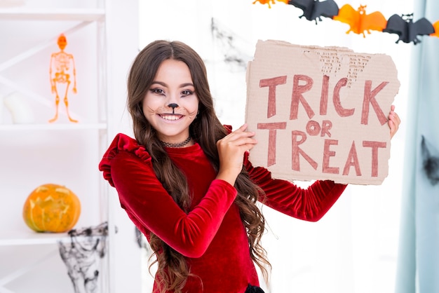 Young girl with face painted ready for halloween