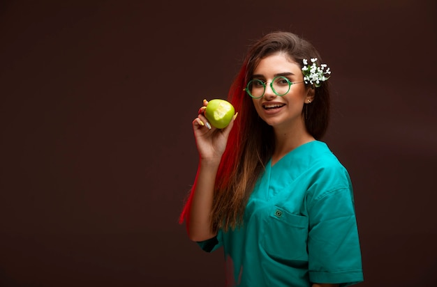 Young girl with a green apple in the hand. 