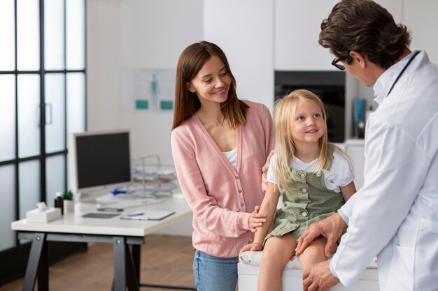 Young girl with her mother at the doctors office for a physical examination