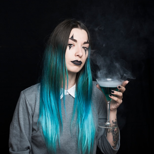 Young girl with spooky makeup and azure hair