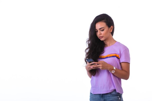 Young girl writing messages or making a video call . 