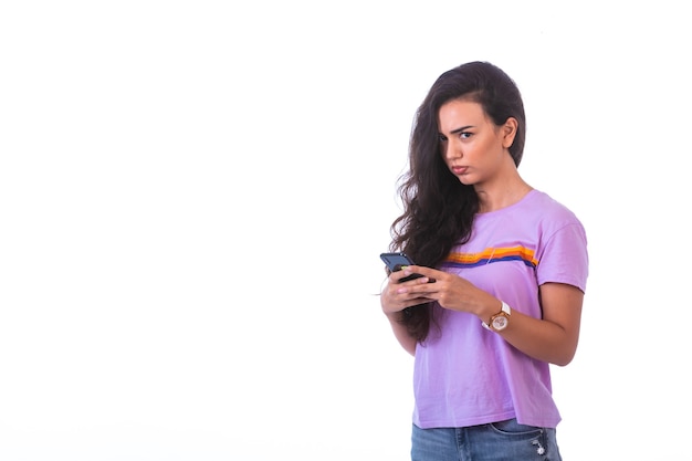 Young girl writing messages or making a video call.