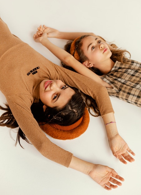 Young girlfriends laid on floor