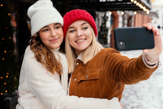 Young girlfriends taking photos