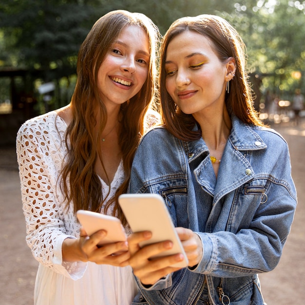 Young girlfriends with mobile