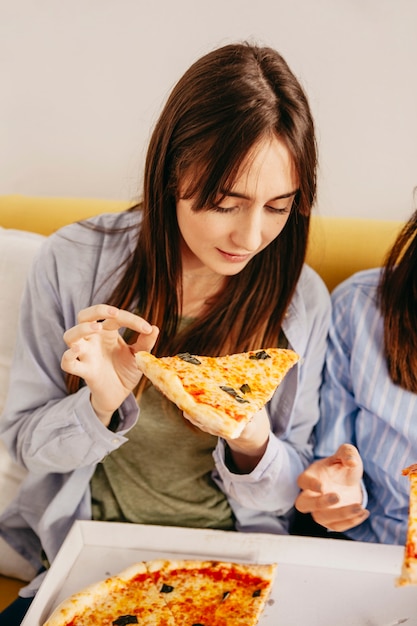 Free Photo young girls eating pizza