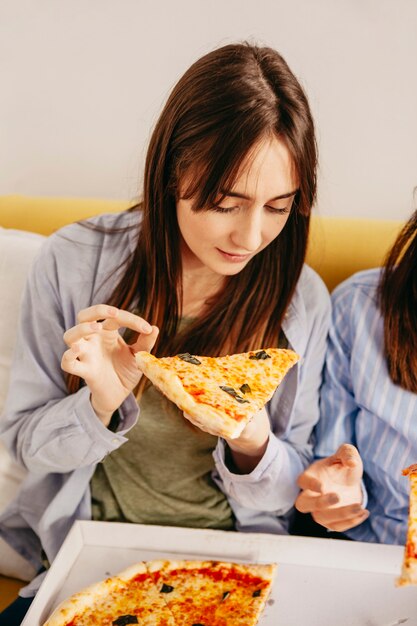 Young girls eating pizza