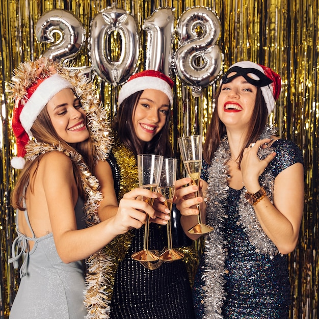 Young girls with champagne on new year party