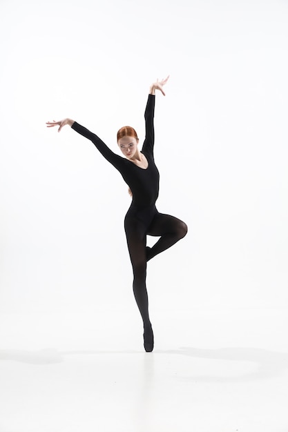 Young and graceful ballet dancer in minimal black style isolated on white