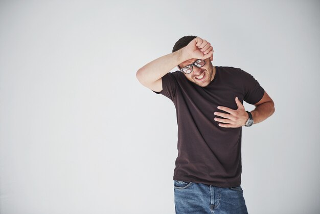 A young guy in casual clothes holds on to the heart and the head