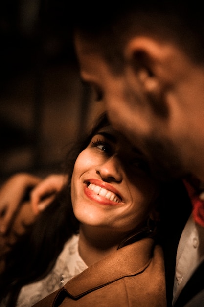 Young guy hugging happy lady 